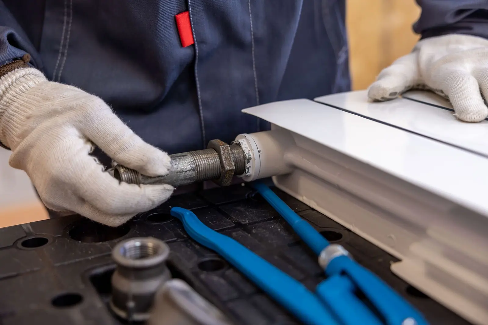 Technician connecting a fitting during a water system installation